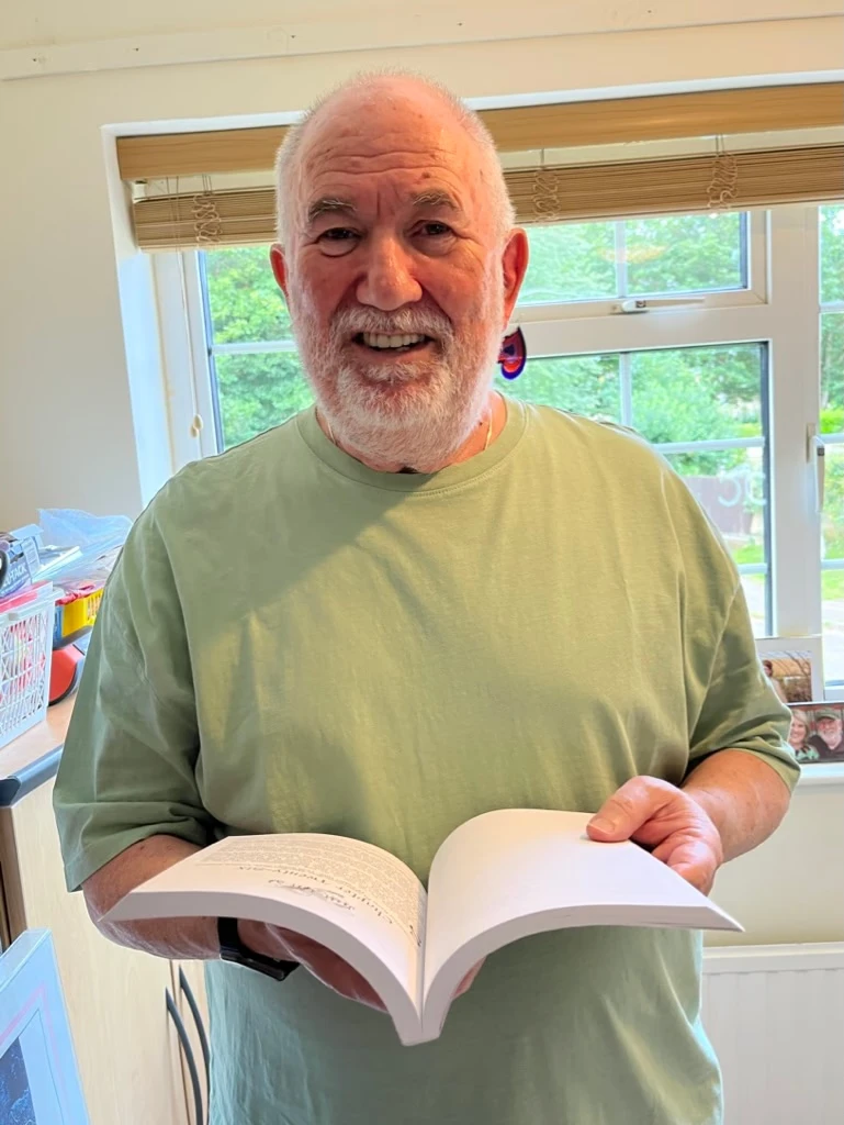 Tony Klinger holding an open book