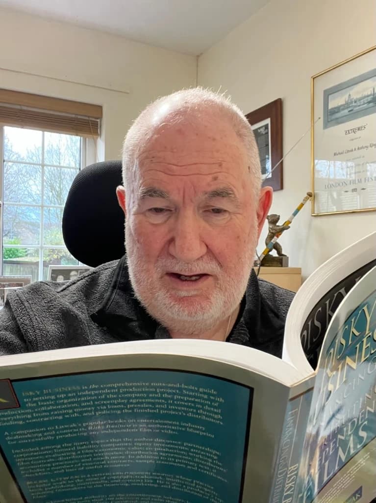 Tony Klinger reading at his desk